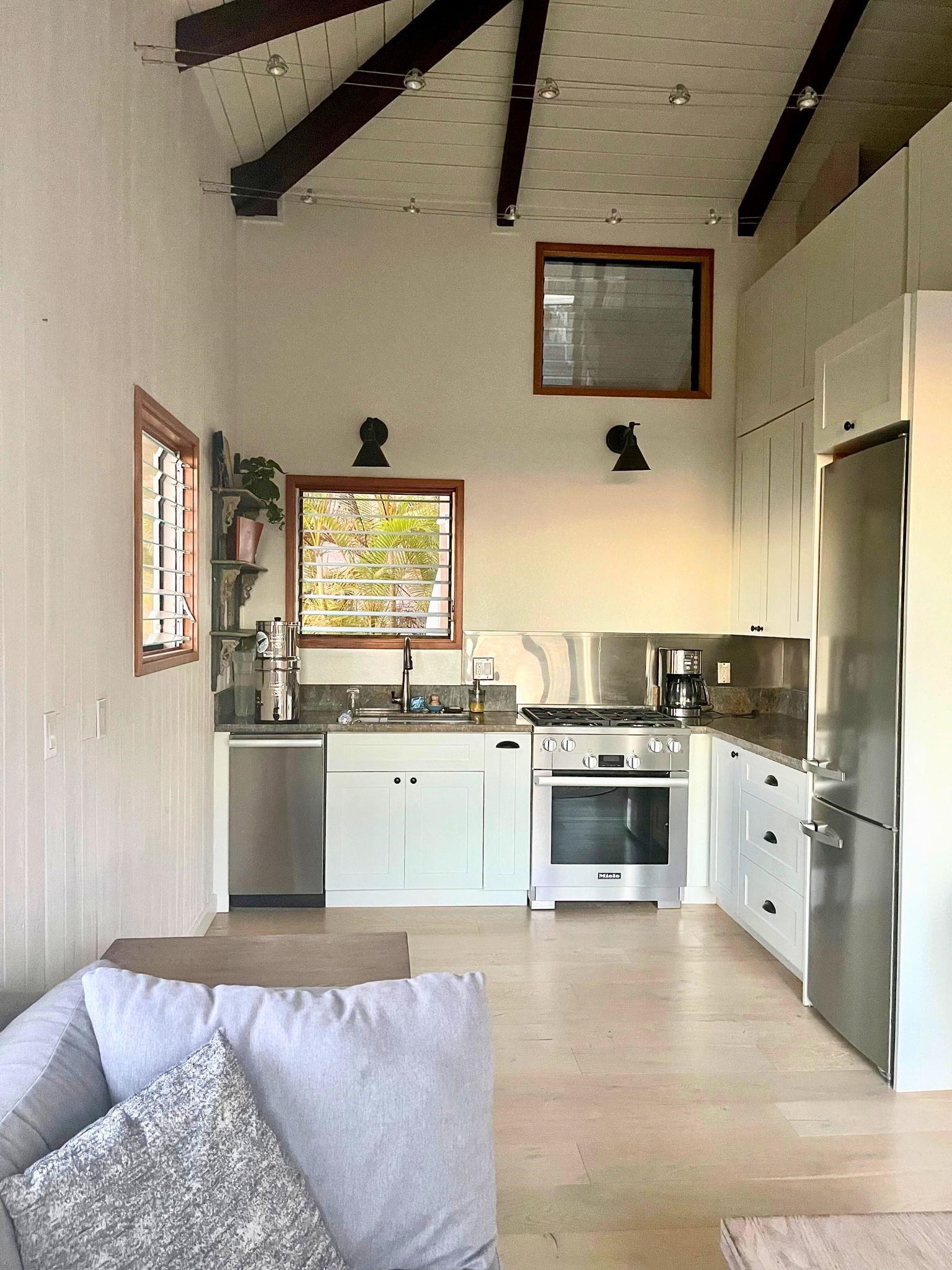 216 Keoni Place Kula, HI 96790 - Photo 21 of 29 a kitchen with a stove a sink and a refrigerator