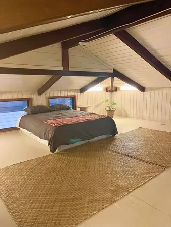a bathroom with a toilet a mirror and shower curtain