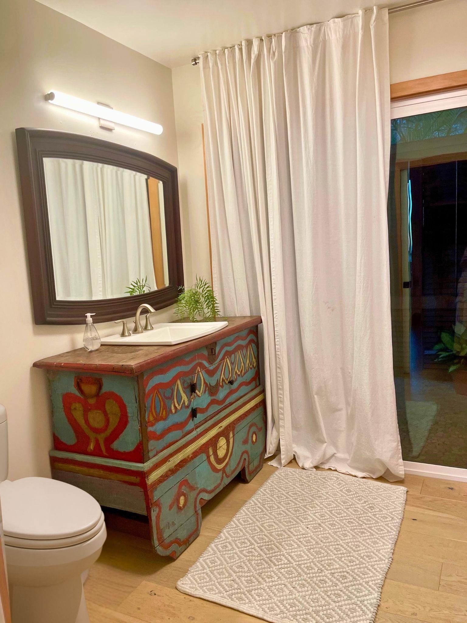 216 Keoni Place Kula, HI 96790 - Photo 24 of 29 a bathroom with a toilet a mirror and shower curtain