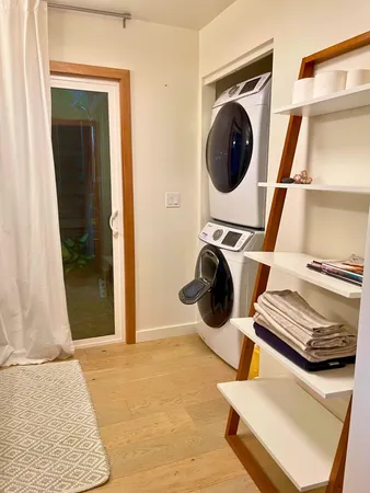 a white bath tub sitting in a bathroom next to a window