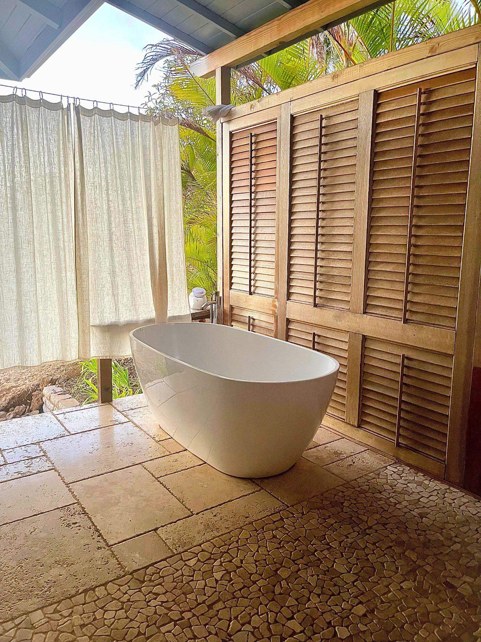216 Keoni Place Kula, HI 96790 - Photo 26 of 29 a white bath tub sitting in a bathroom next to a window