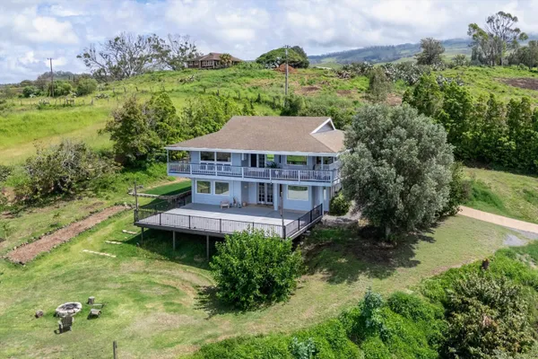 an aerial view of a house with pool garden and lake view