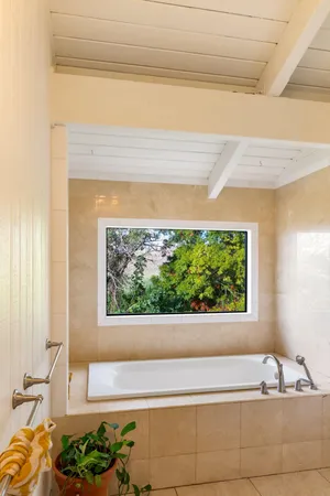 a bathroom with a bathtub and a window
