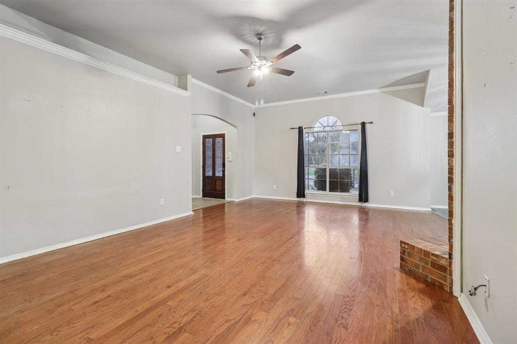 600 North Chattey Road DeSoto, TX 75115 - Photo 15 of 40 a view of an empty room with wooden floor and a window