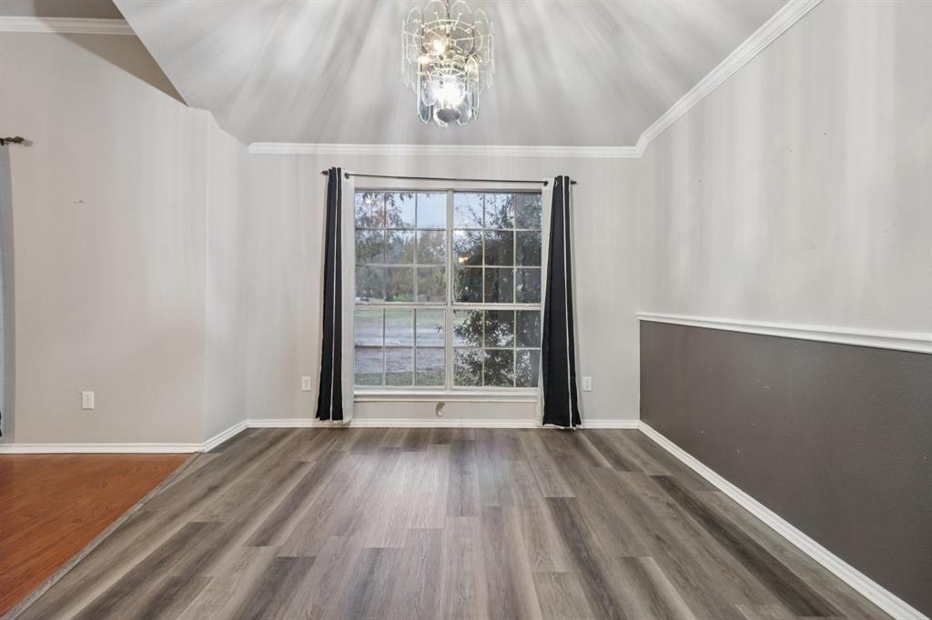 600 North Chattey Road DeSoto, TX 75115 - Photo 16 of 40 a view of an empty room with wooden floor and a window