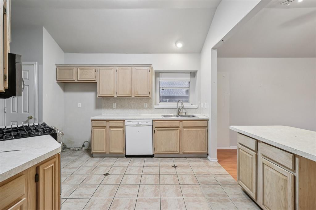 600 North Chattey Road DeSoto, TX 75115 - Photo 19 of 40 a kitchen with a stove sink and cabinets