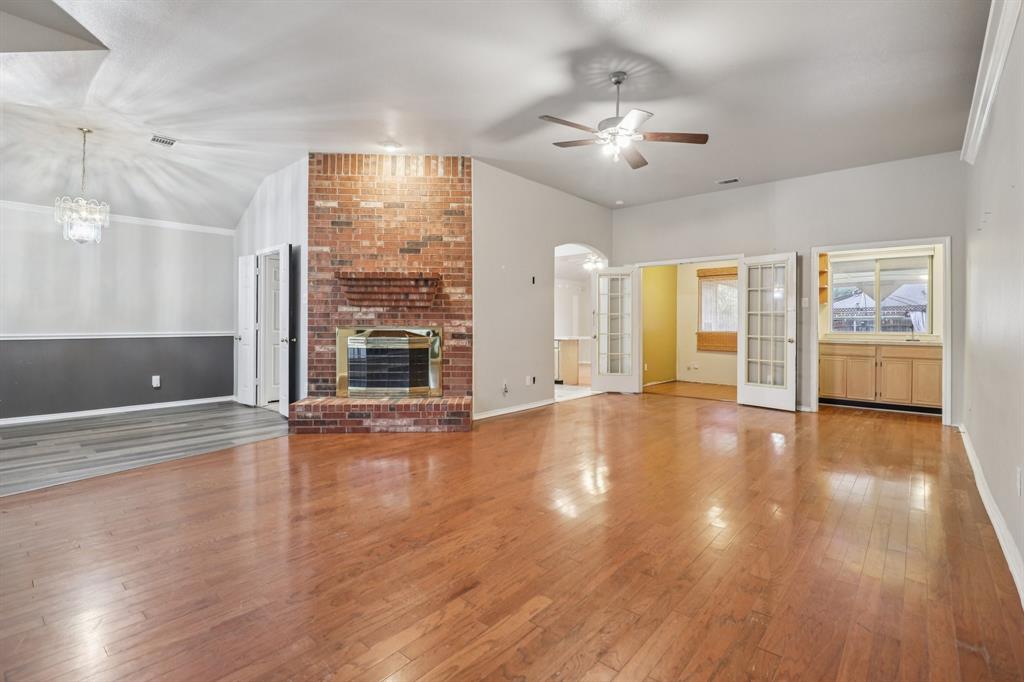 600 North Chattey Road DeSoto, TX 75115 - Photo 2 of 40 a view of an empty room with wooden floor and a window