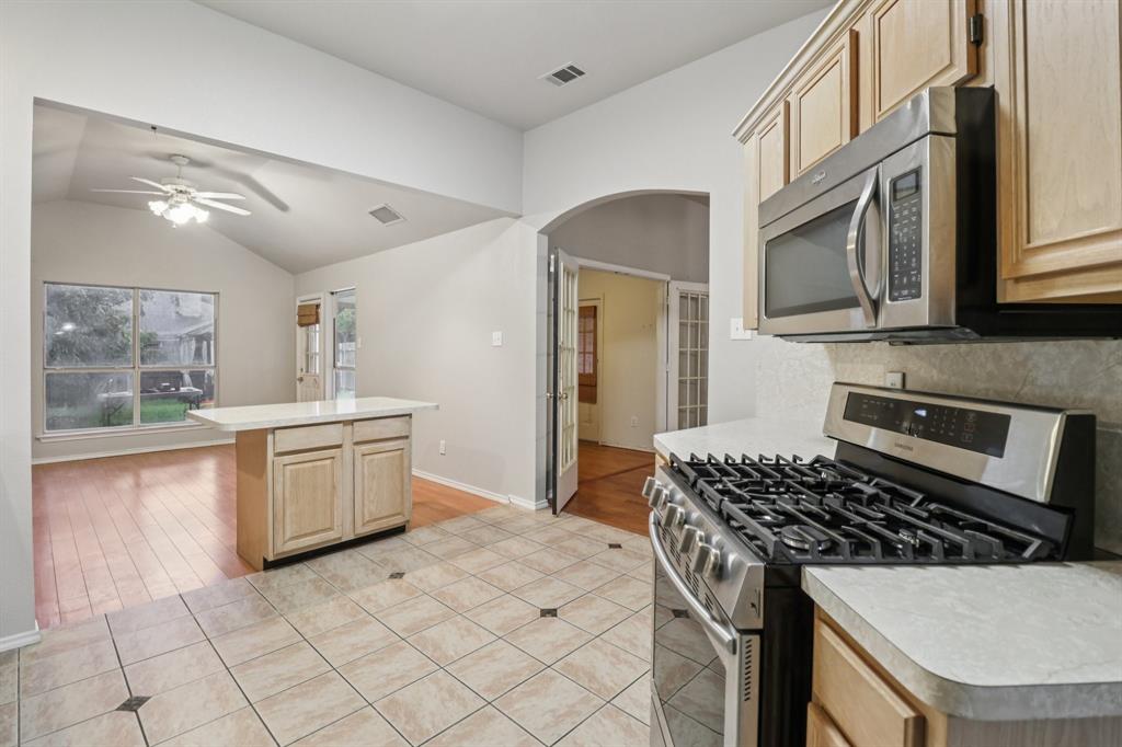600 North Chattey Road DeSoto, TX 75115 - Photo 20 of 40 a kitchen with a stove a sink and a refrigerator