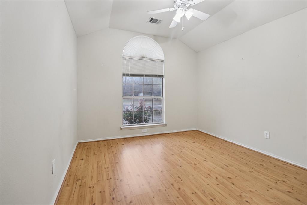 600 North Chattey Road DeSoto, TX 75115 - Photo 30 of 40 an empty room with wooden floor chandelier fan and windows