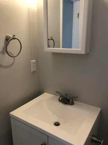 a bathroom with a sink and mirror