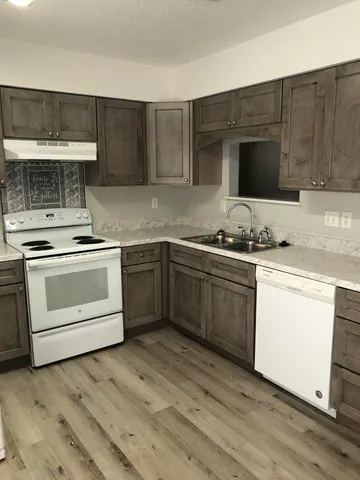 a kitchen with a sink stove and cabinets