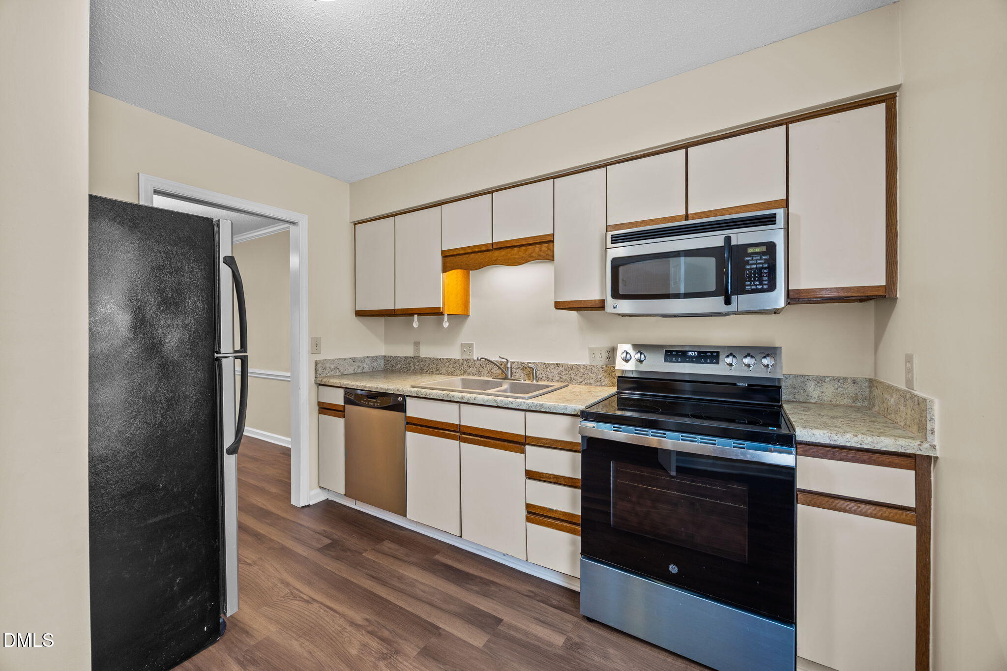 3112 Coachman's Way Durham, NC 27705 - Photo 10 of 32 a kitchen with stainless steel appliances a stove microwave and a refrigerator