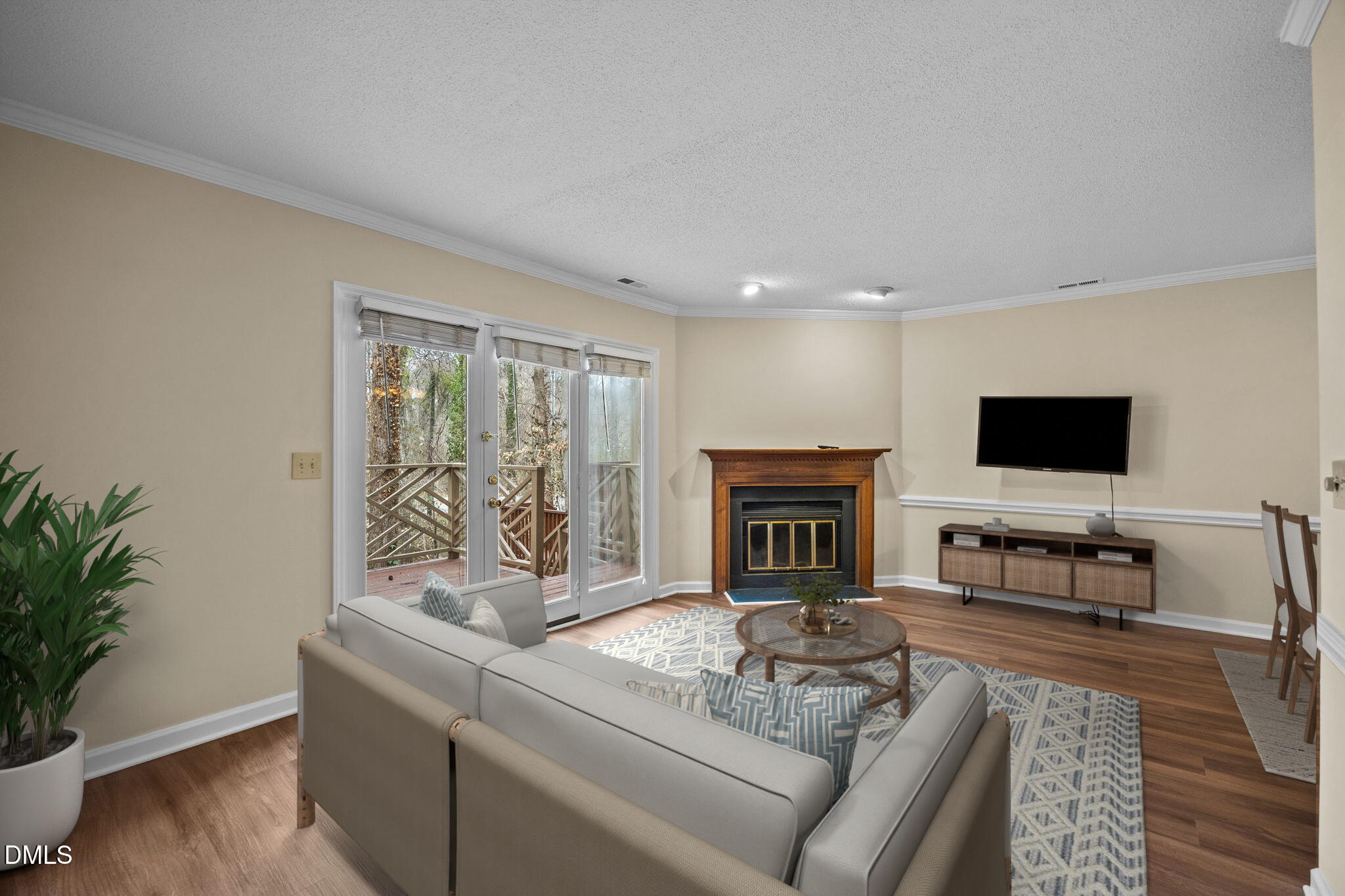 3112 Coachman's Way Durham, NC 27705 - Photo 3 of 32 a living room with furniture a flat screen tv and a fireplace