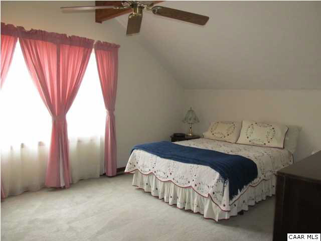 15 Oak Grove Road Palmyra, VA 22963 - Photo 20 of 25 a bed sitting in a room next to a window
