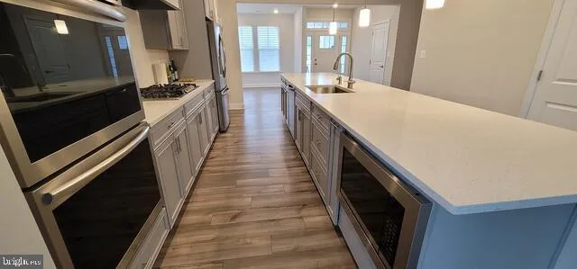 a kitchen with counter top space and wooden floor