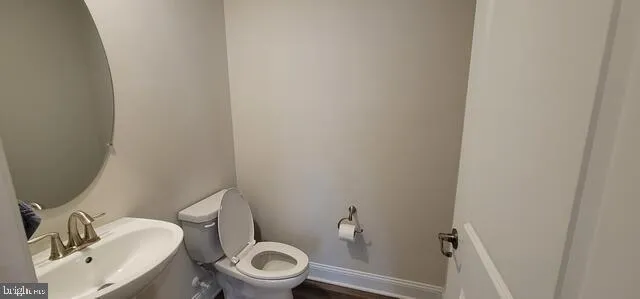 a white toilet sitting next to a bathroom sink