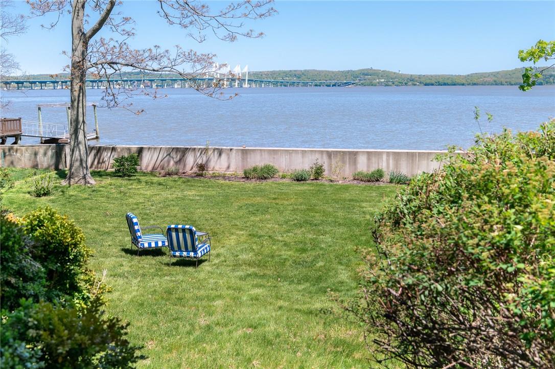 180 River Road Nyack, NY 10960 - Photo 1 of 1 a view of a lake with a big yard and palm trees