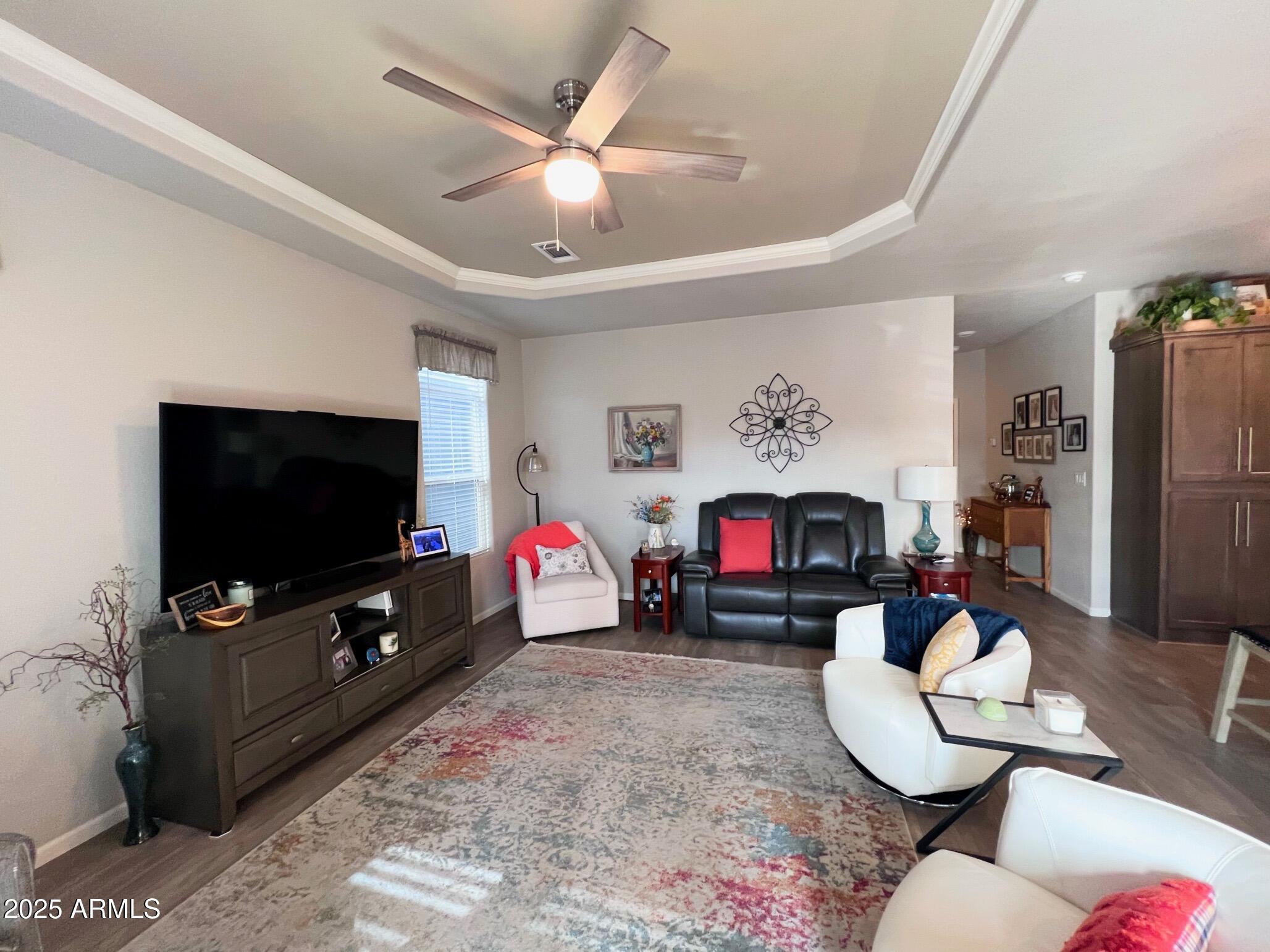 2929 East Main Street, Unit 116 Mesa, AZ 85213 - Photo 12 of 39 a living room with furniture a flat screen tv and a fireplace