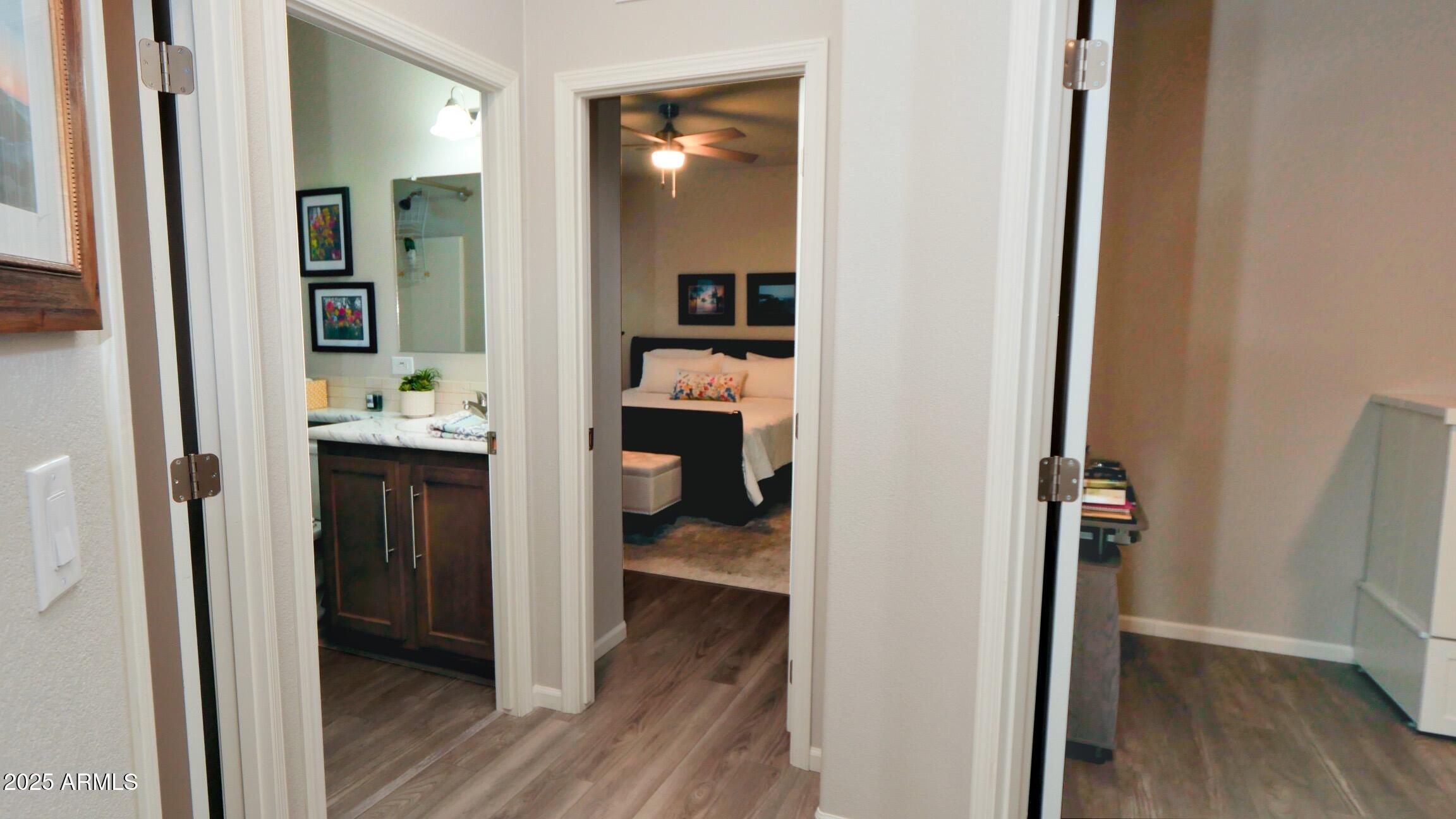 2929 East Main Street, Unit 116 Mesa, AZ 85213 - Photo 14 of 39 a view of a hallway with wooden floor and a bathroom