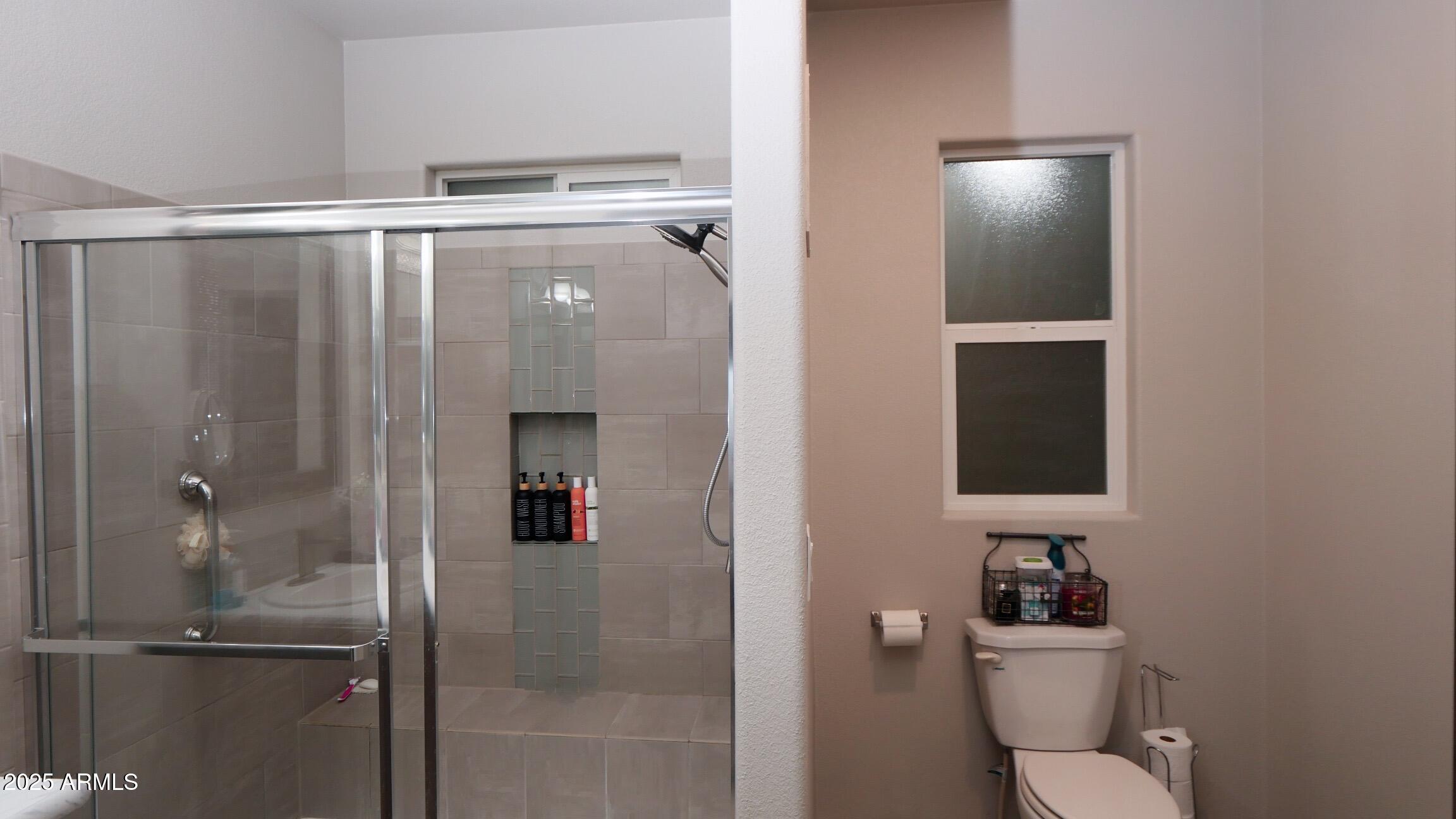 2929 East Main Street, Unit 116 Mesa, AZ 85213 - Photo 16 of 39 a bathroom with a shower and a toilet