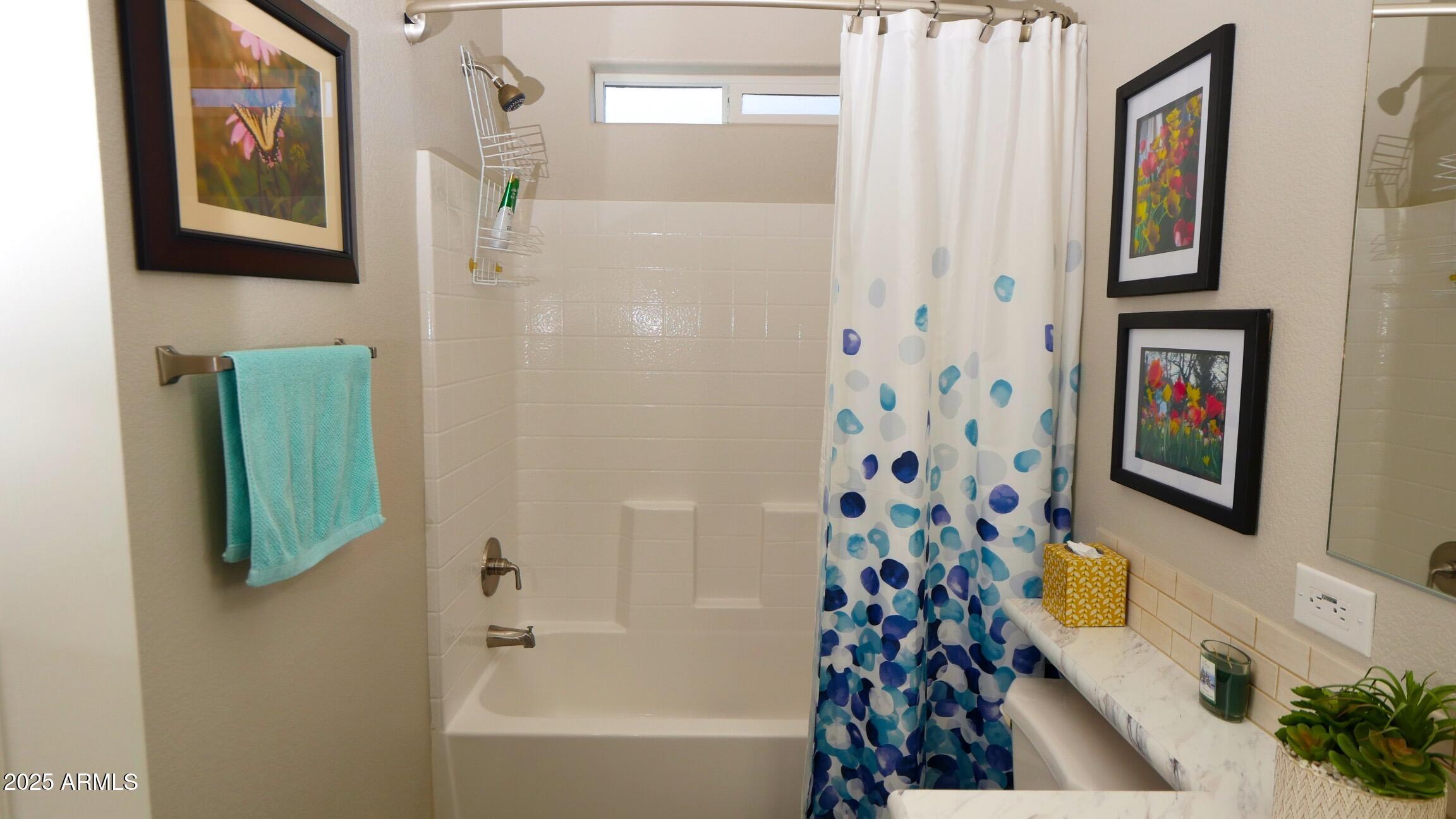 2929 East Main Street, Unit 116 Mesa, AZ 85213 - Photo 22 of 39 a bathroom with a tub and a shower curtain