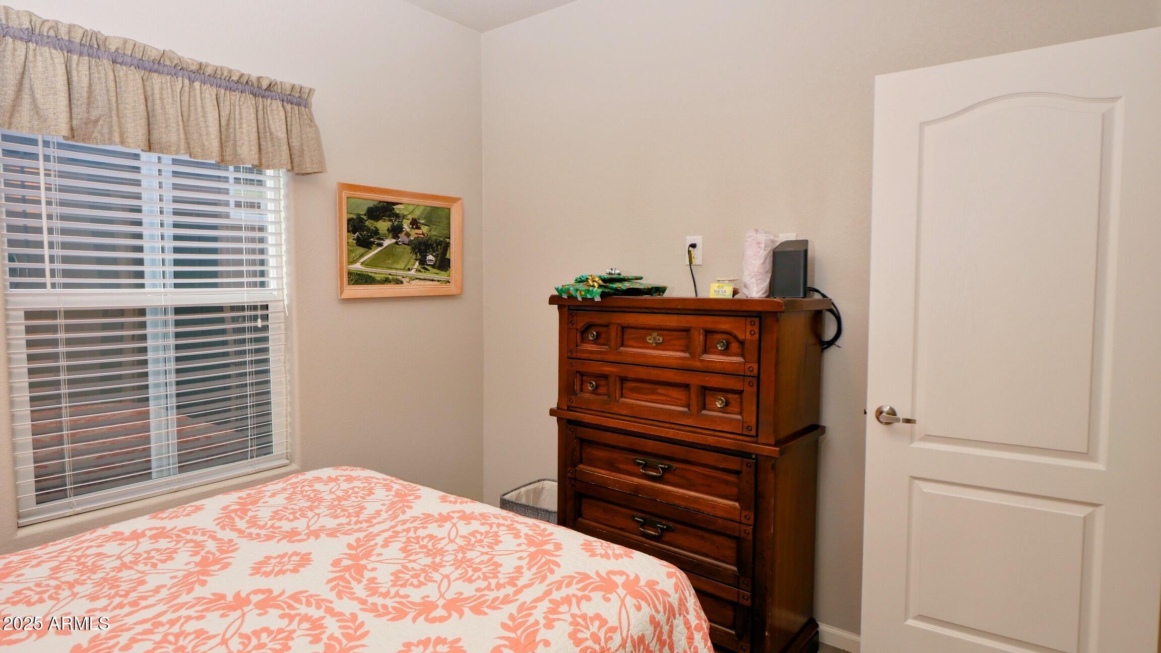 2929 East Main Street, Unit 116 Mesa, AZ 85213 - Photo 25 of 39 a bedroom with a bed and a window