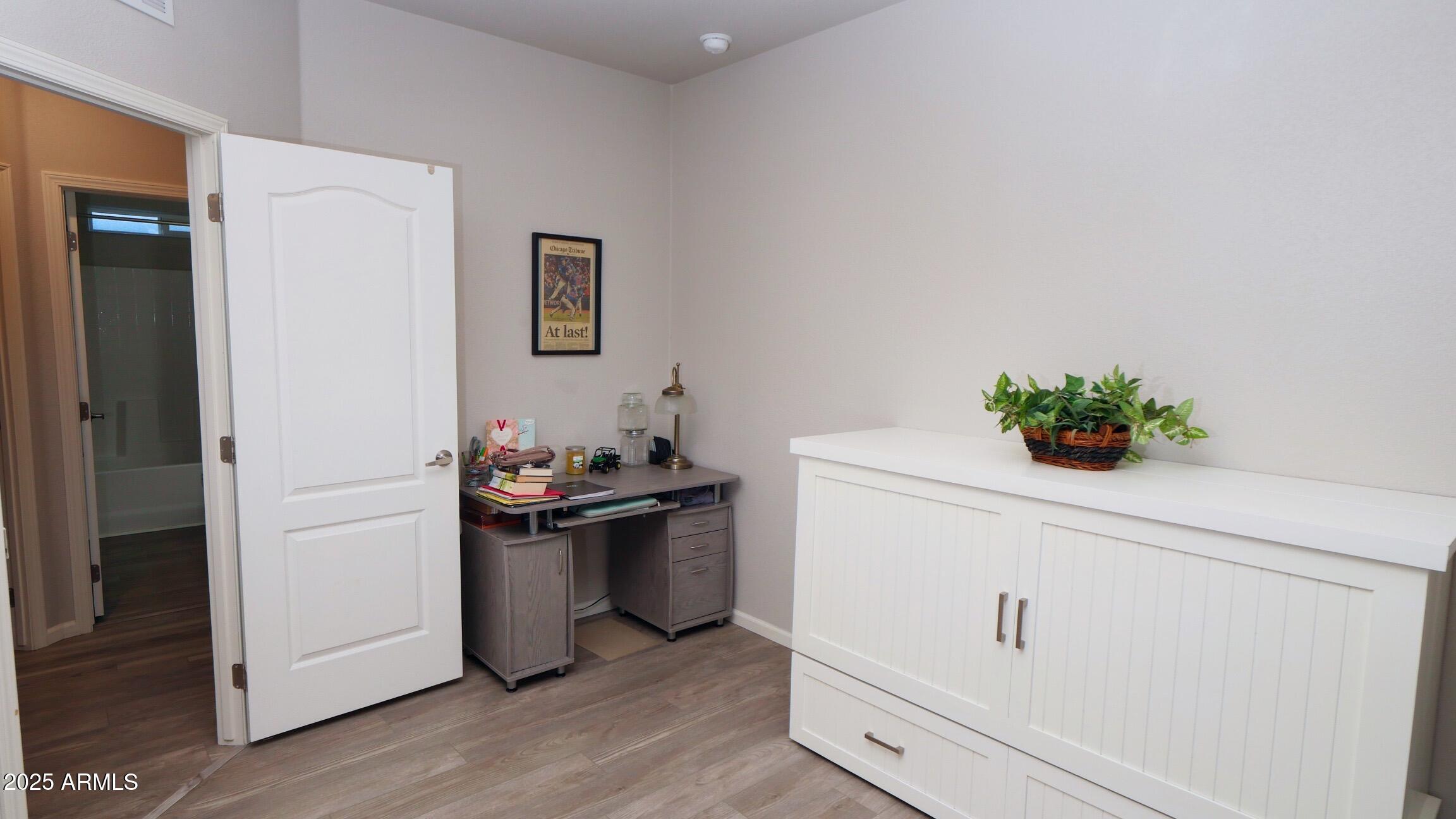 2929 East Main Street, Unit 116 Mesa, AZ 85213 - Photo 28 of 39 a kitchen with a refrigerator and white cabinets