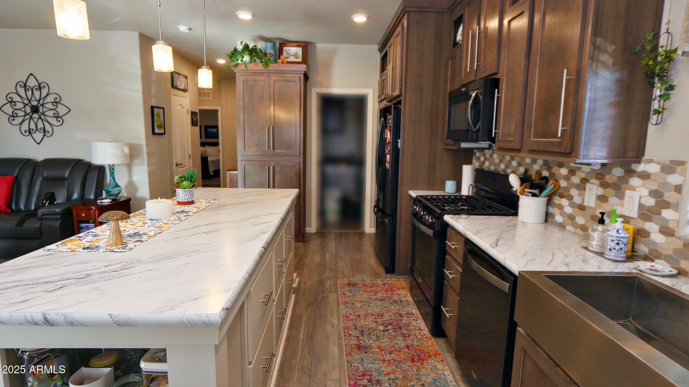 2929 East Main Street, Unit 116 Mesa, AZ 85213 - Photo 5 of 39 a kitchen with stainless steel appliances kitchen island granite countertop a refrigerator a sink and dishwasher