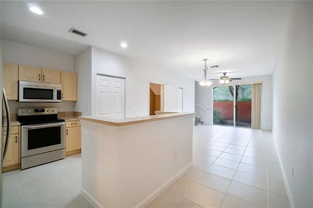 a kitchen with granite countertop a stove and a microwave