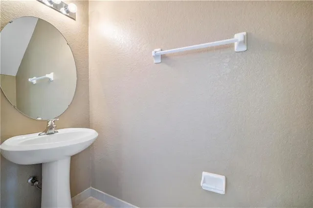 a bathroom with a sink a mirror and shower