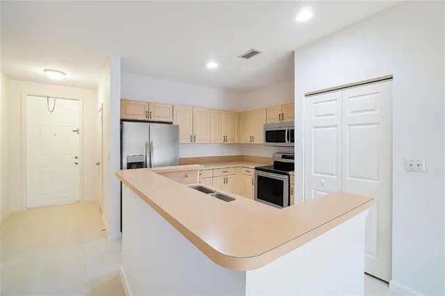 a kitchen with a stove a sink and a refrigerator