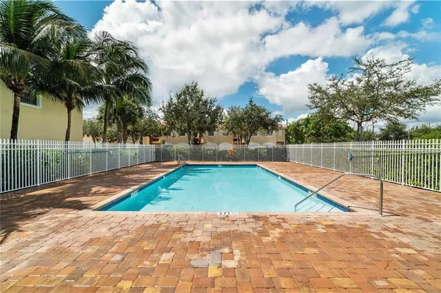 a view of swimming pool with a patio and a yard