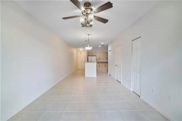 a view of a kitchen with a sink and a chandelier fan