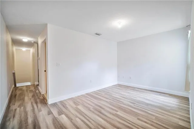 a view of a room with wooden floor