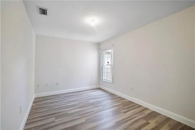 a view of room with wooden floor