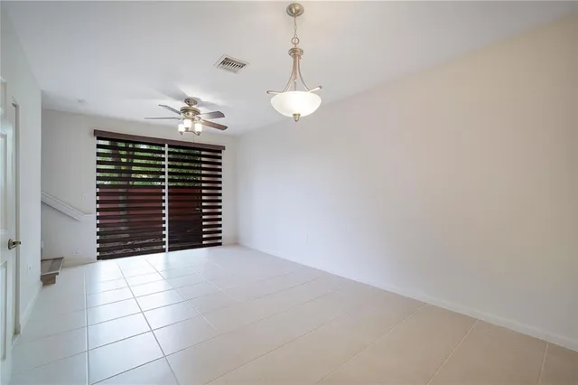 a view of kitchen and a chandelier fan