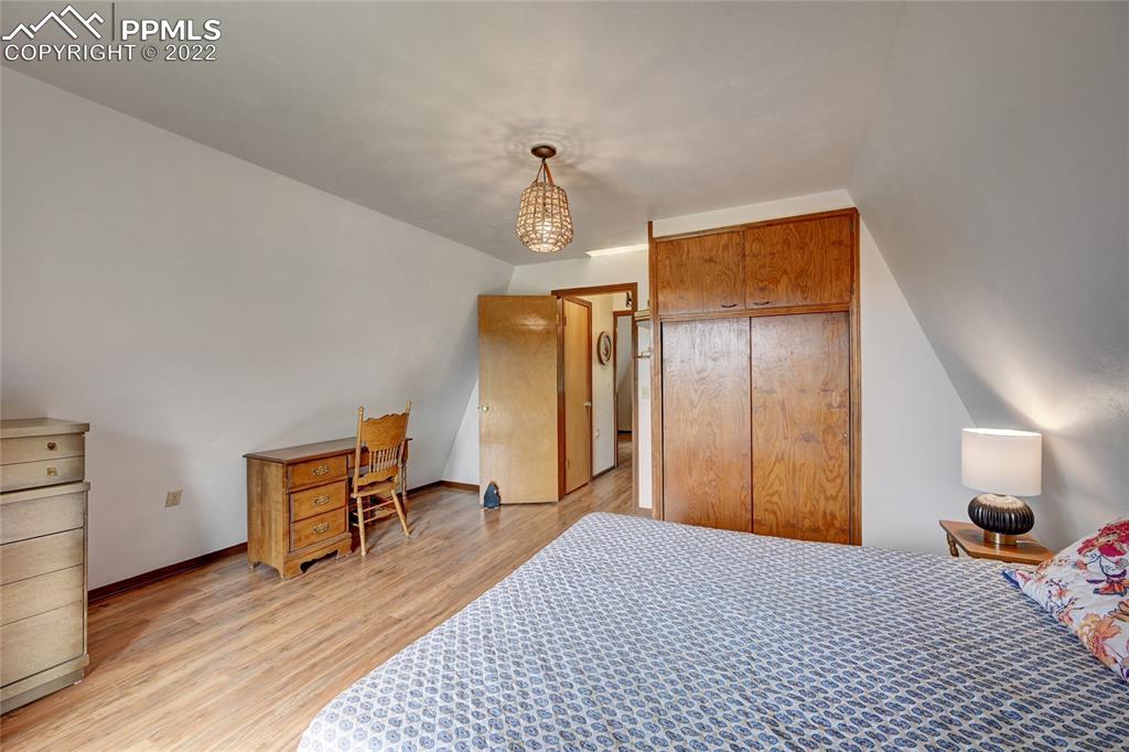 67 Pine Street Rye, CO 81069 - Photo 35 of 42 a bedroom with a bed and wooden floor