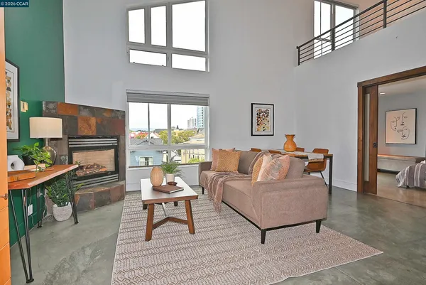a living room with furniture a large window and a fireplace