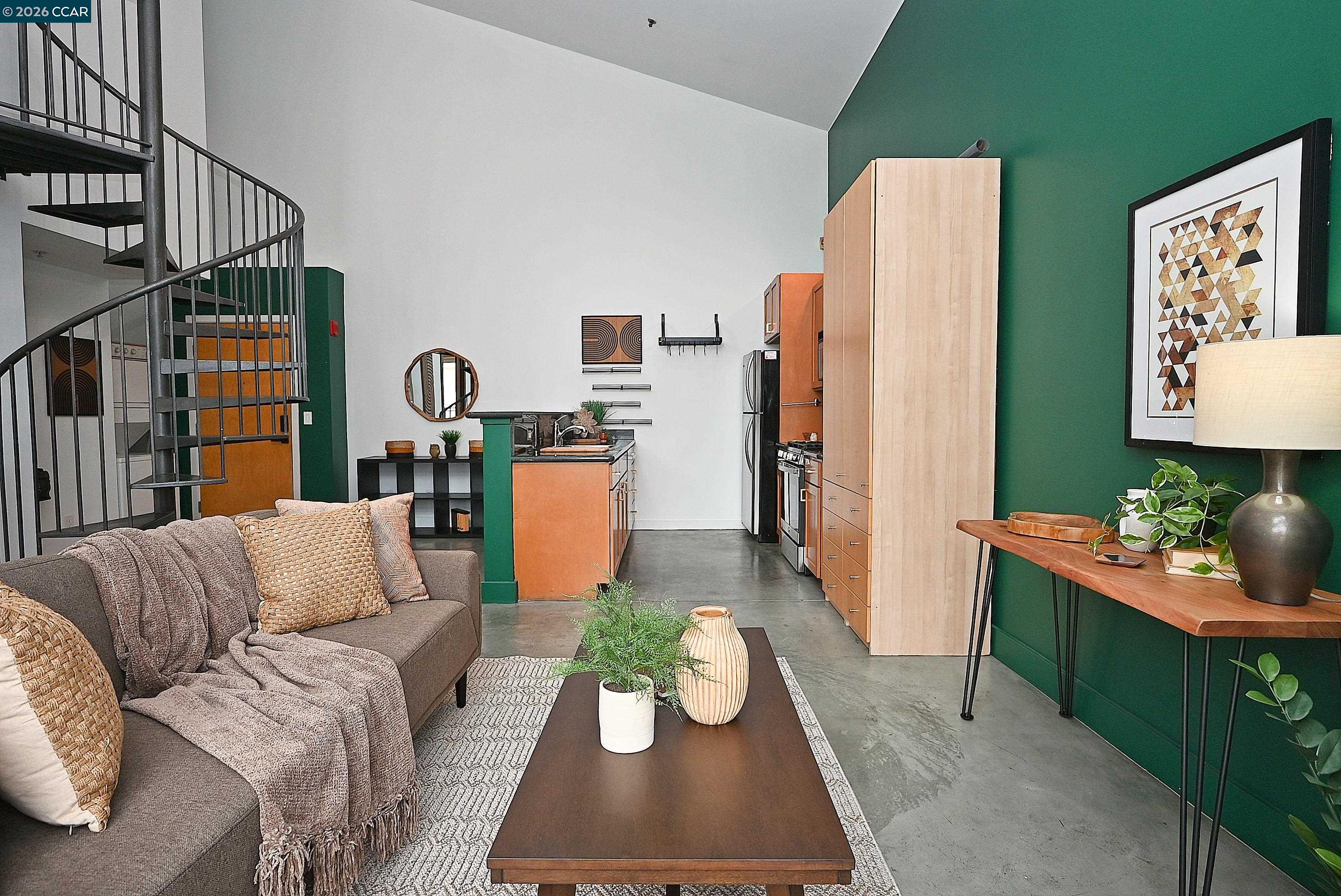 675 8th Street, Unit 15 Oakland, CA 94607 - Photo 13 of 38 a living room with furniture kitchen view and a window