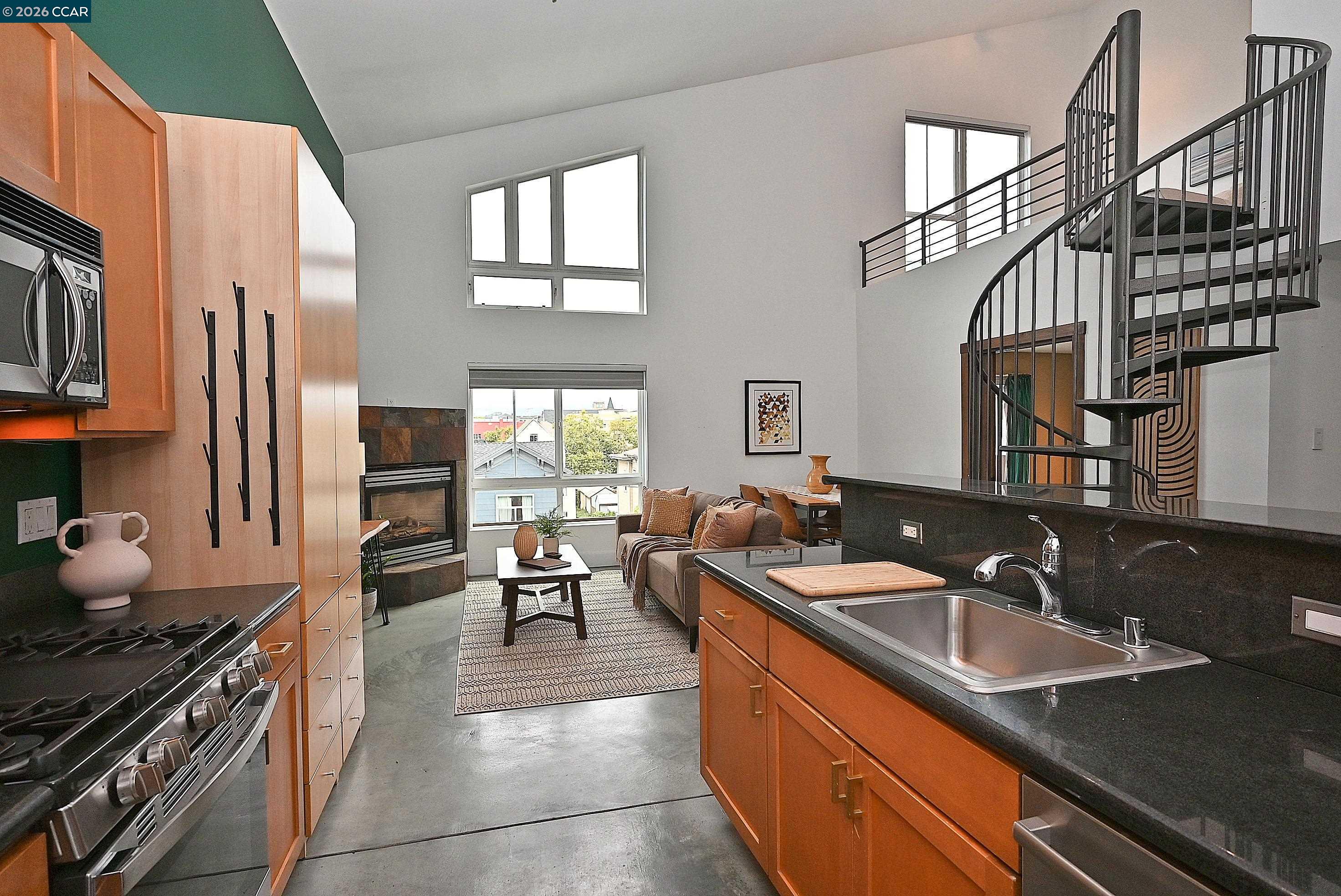 675 8th Street, Unit 15 Oakland, CA 94607 - Photo 16 of 38 a kitchen that has a sink and a stove