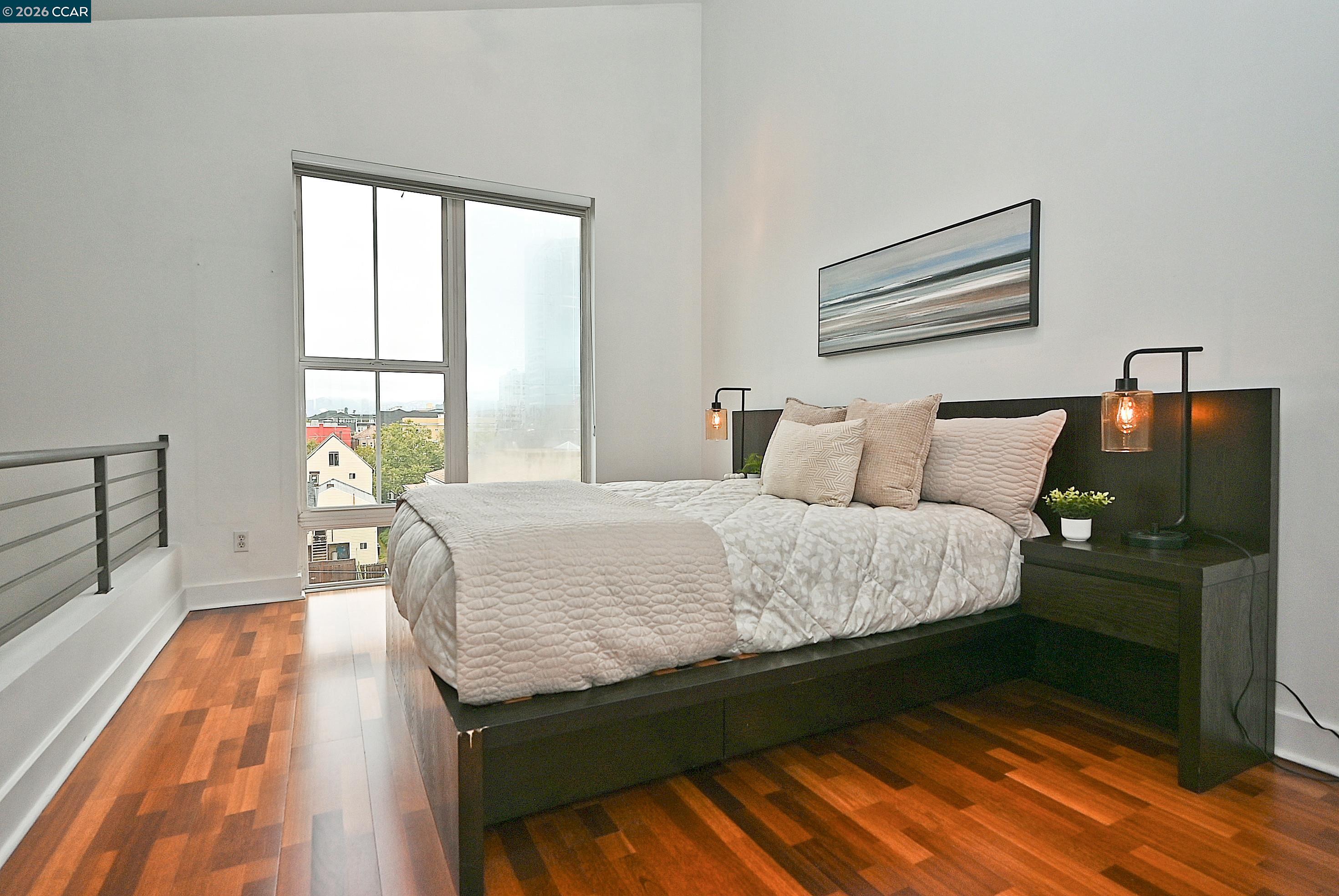 675 8th Street, Unit 15 Oakland, CA 94607 - Photo 18 of 38 a bed sitting in a bedroom next to a window