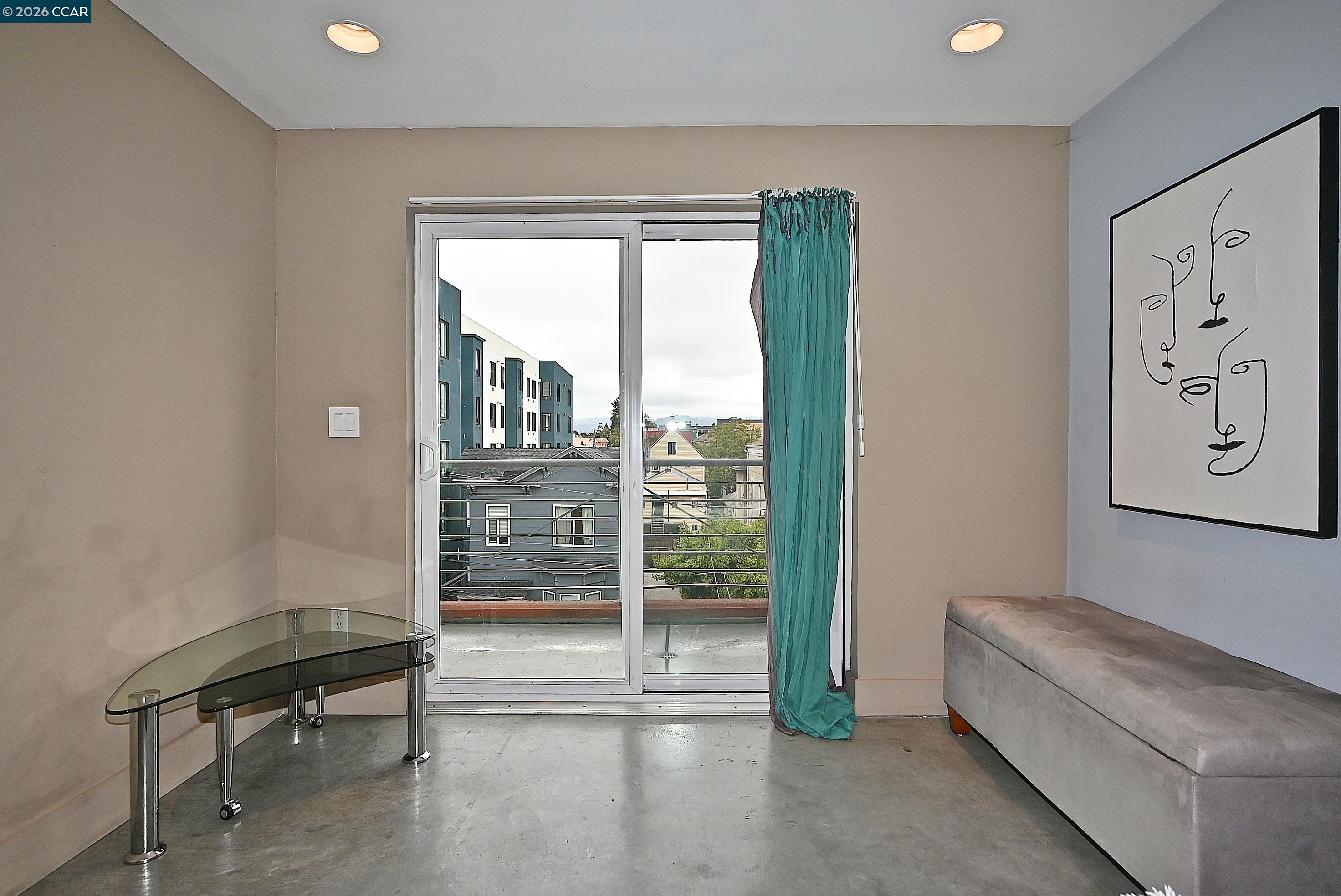675 8th Street, Unit 15 Oakland, CA 94607 - Photo 24 of 38 a living room with furniture and a window