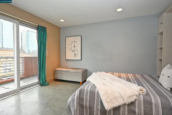 a bedroom with a bed and a view of living room