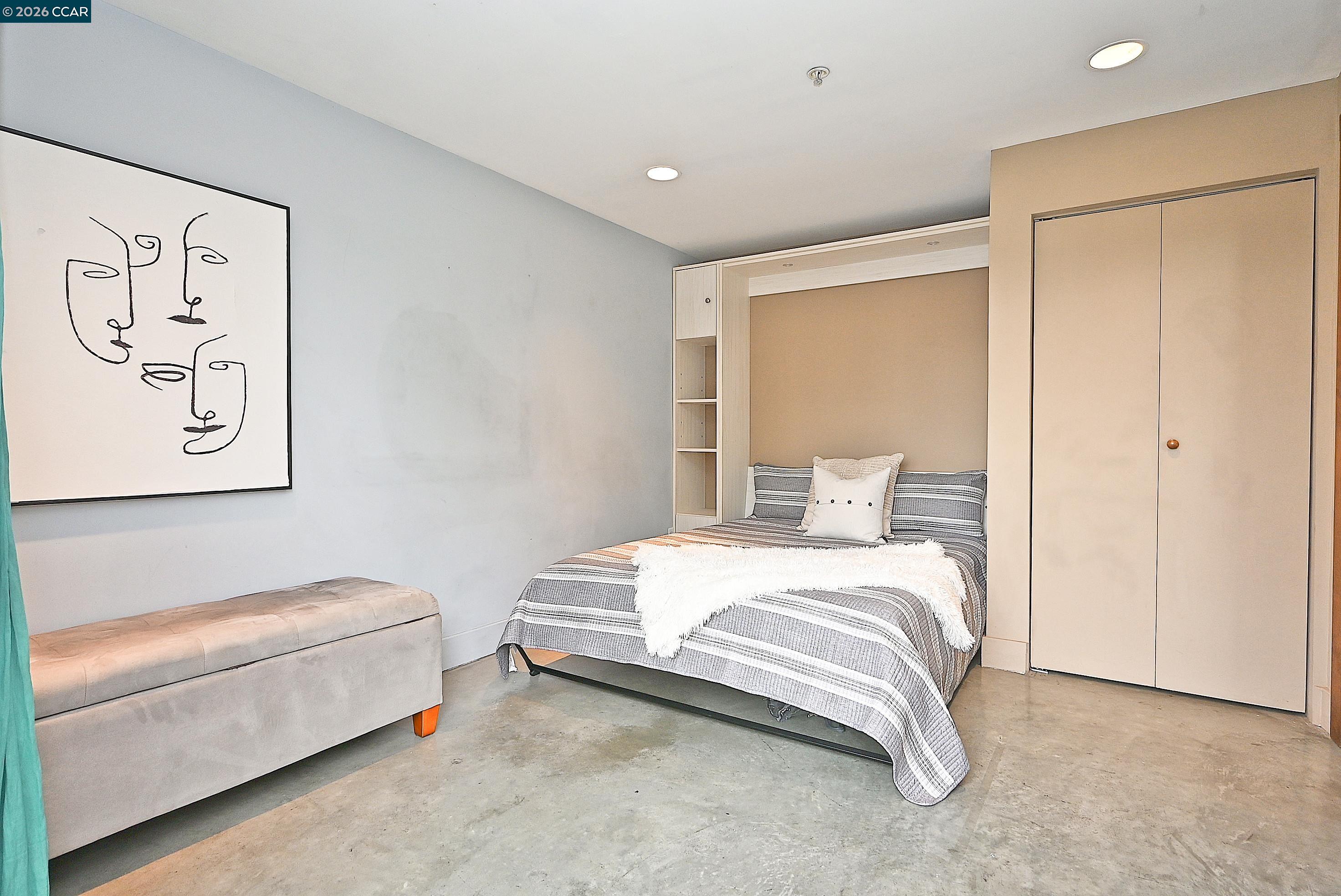 675 8th Street, Unit 15 Oakland, CA 94607 - Photo 28 of 38 a bedroom with a bed and a couch