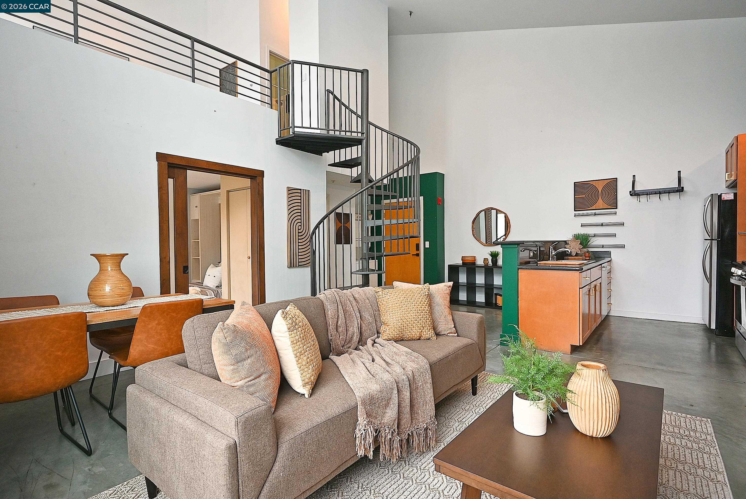 675 8th Street, Unit 15 Oakland, CA 94607 - Photo 31 of 38 a living room with furniture a rug and a lamp