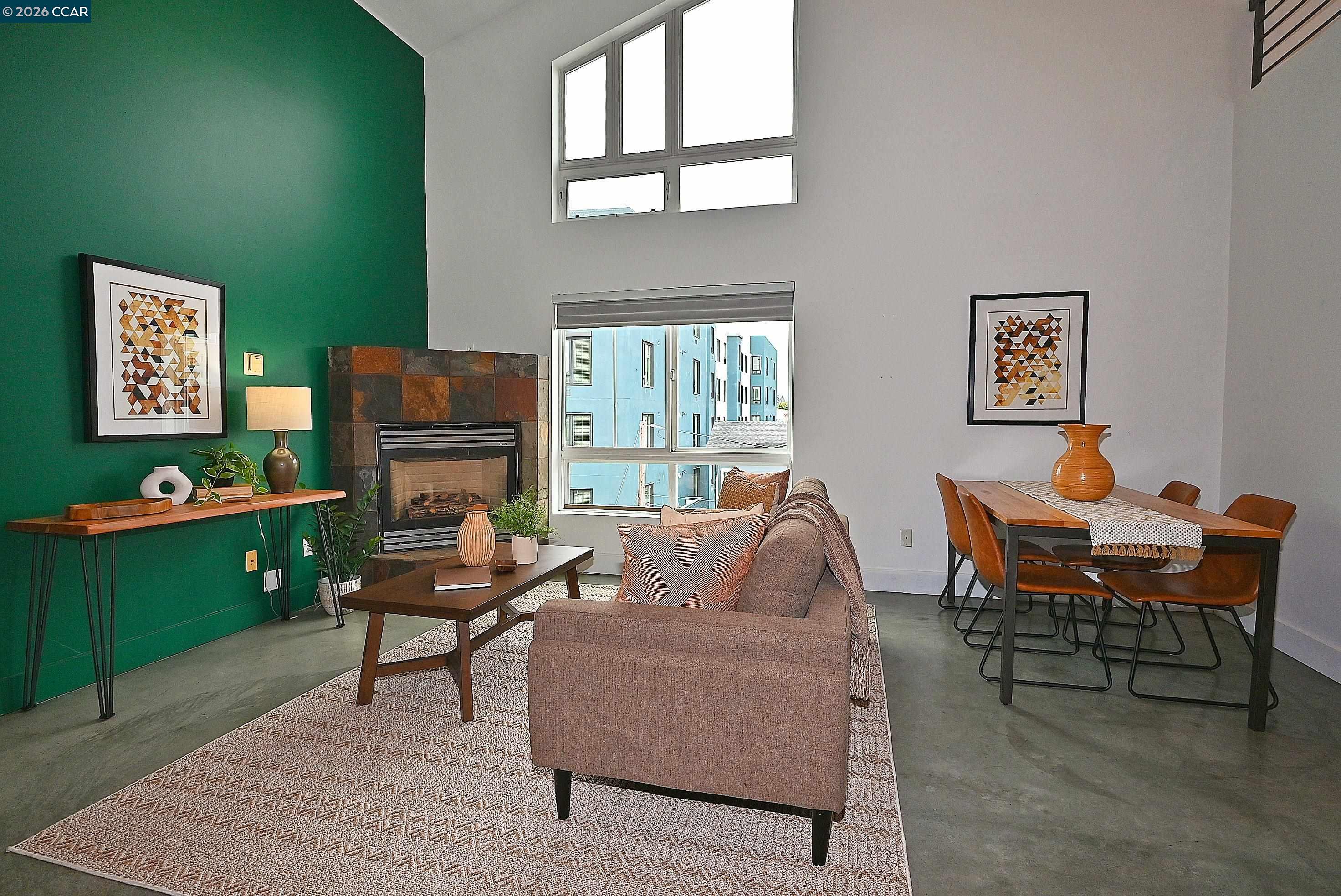 675 8th Street, Unit 15 Oakland, CA 94607 - Photo 32 of 38 a living room with furniture a window and a fireplace