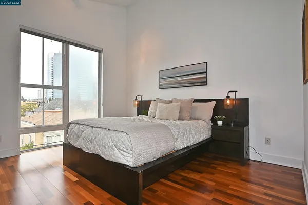 a bedroom with a bed and wooden floor