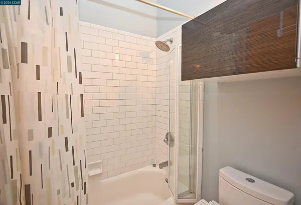 a bathroom with a shower and a toilet