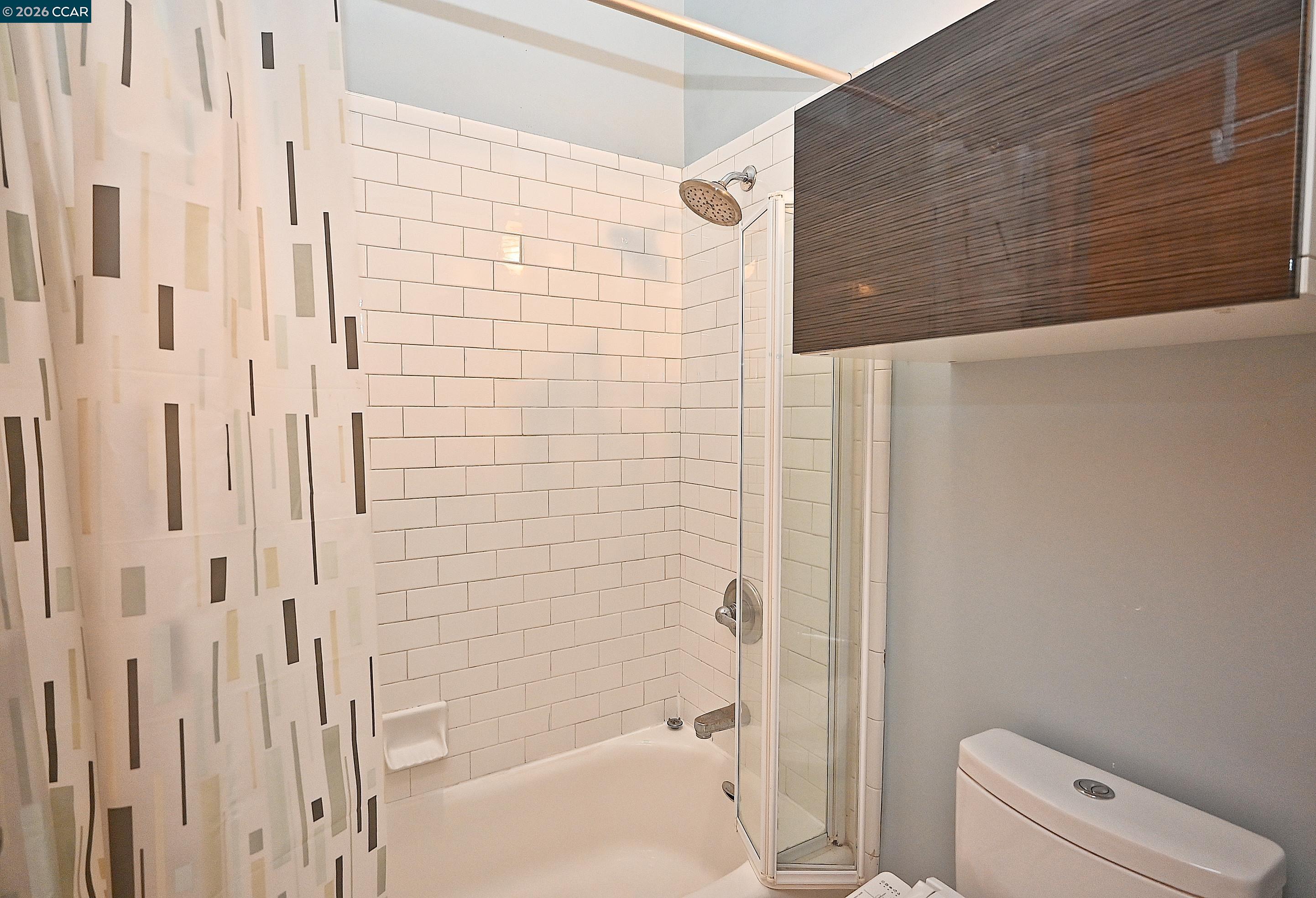 675 8th Street, Unit 15 Oakland, CA 94607 - Photo 34 of 38 a bathroom with a shower and a toilet