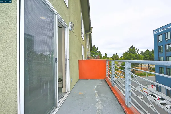 a balcony with view of outdoor space